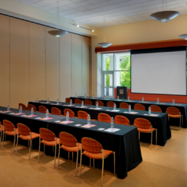 Three rows of tables and chairs in a room